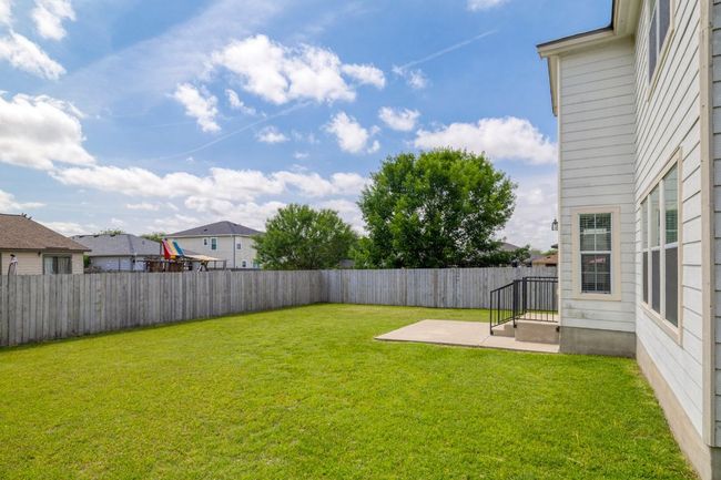 View of yard with a fenced backyard, a residential view, and a patio area | Image 31