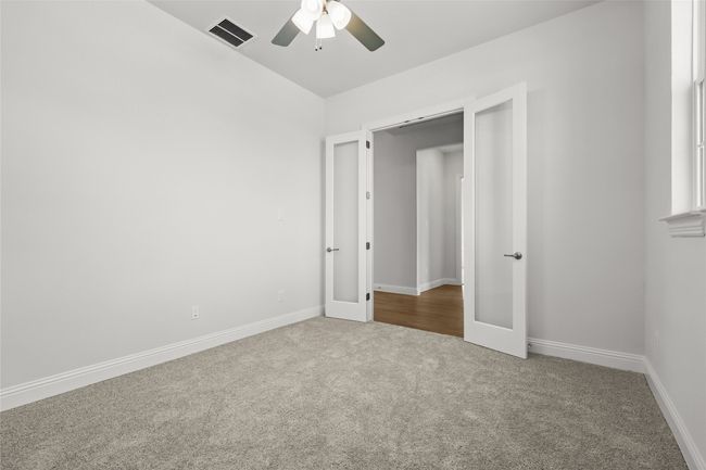Unfurnished bedroom featuring visible vents, baseboards, ceiling fan, french doors, and carpet flooring | Image 26