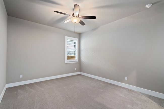 Unfurnished room featuring a ceiling fan, carpet flooring, and a smoke detector | Image 20