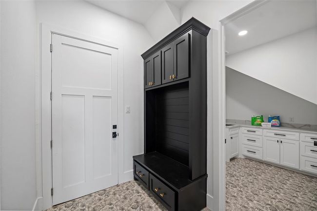Stylish mudroom featuring sleek cabinetry and practical storage solutions, perfect for organizing outdoor gear and maintaining a tidy home entrance. | Image 31