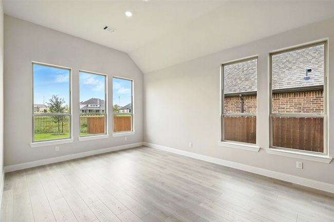 Empty room featuring lofted ceiling, light wood-style flooring, and recessed lighting | Image 8