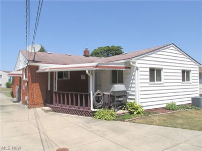 Rear View of home with cooling unit, Grill and Deck off Family Room Addition | Image 3