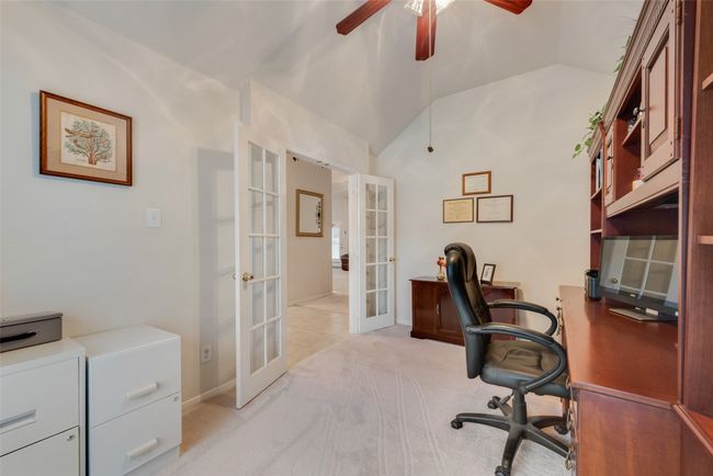 Office area with french doors, a ceiling fan, lofted ceiling, light colored carpet, and baseboards | Image 21