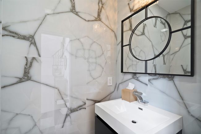 Bathroom featuring tile walls and vanity | Image 13
