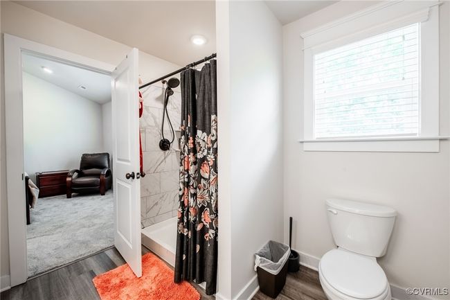 Full bathroom with wood finished floors, a tile shower, and recessed lighting | Image 20