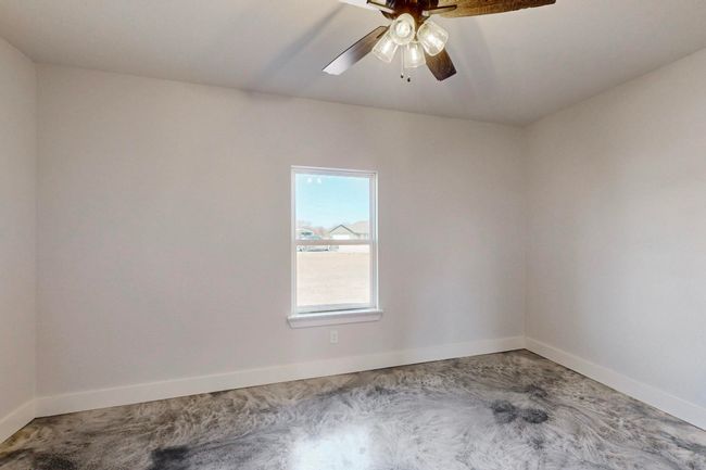 Carpeted spare room featuring baseboards and ceiling fan | Image 33