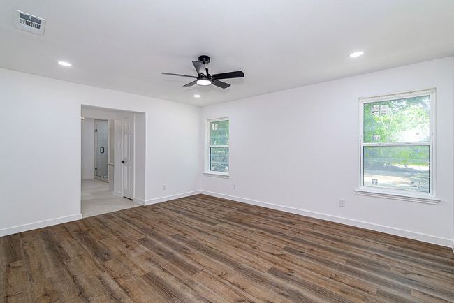 Spare room with ceiling fan, wood finished floors, healthy amount of natural light, baseboards, and recessed lighting | Image 19