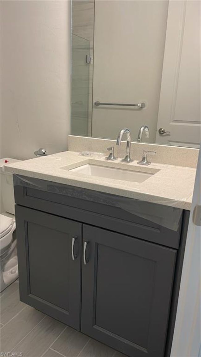 Guest bathroom with quartz countertops and soft-close cabinets | Image 21