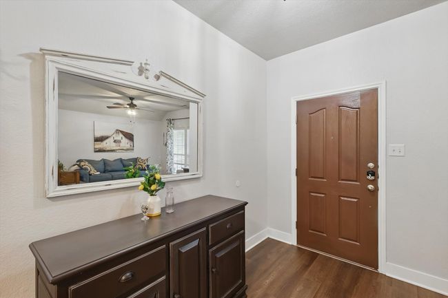 Entryway with dark wood-style floors and ceiling fan | Image 5