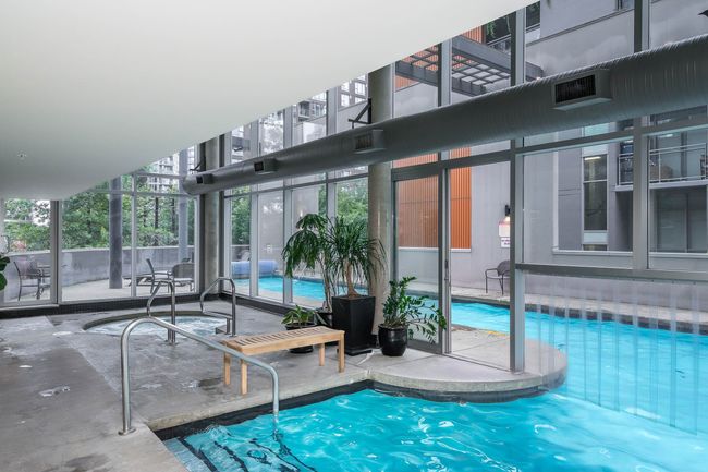 Community pool with a patio and a city view | Image 36