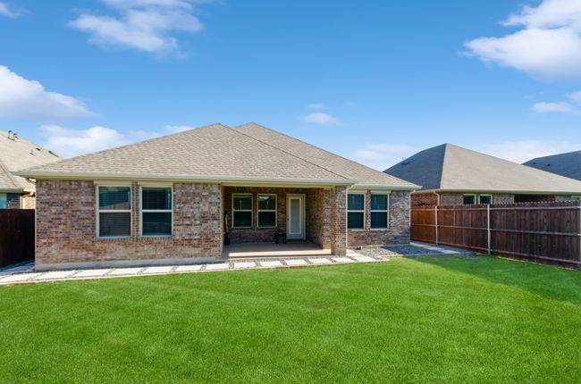 Back of house with brick siding, a patio, and a shingled roof | Image 31
