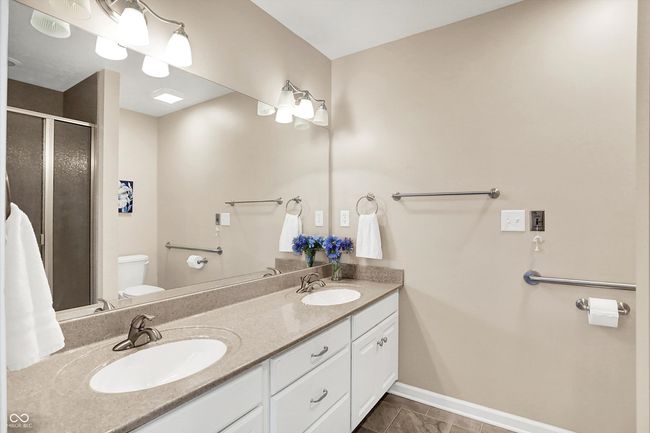 Master bathroom with toilet, double vanity, a shower stall | Image 26