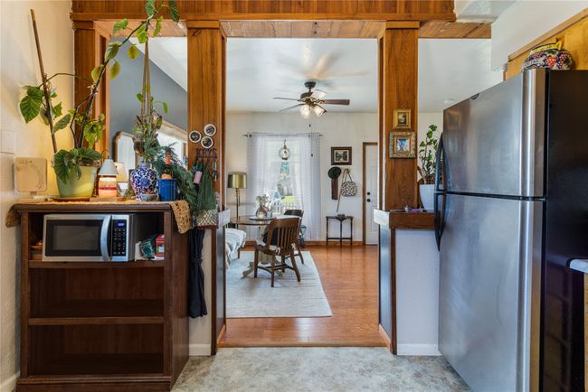 Kitchen with light carpet, light wood-style floors, ceiling fan, and stainless steel appliances | Image 10