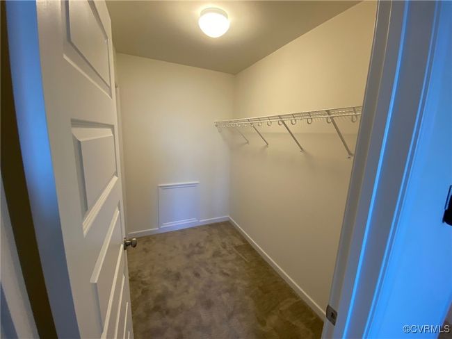 Walk in closet with dark carpet | Image 29