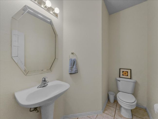 Half bathroom featuring toilet and tile patterned flooring | Image 14