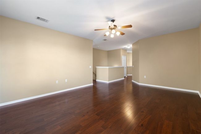 Unfurnished room with a ceiling fan, dark wood finished floors, and baseboards | Image 25