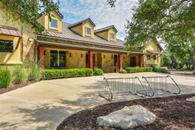 View of front of clubhouse featuring a porch and stone siding | Image 36