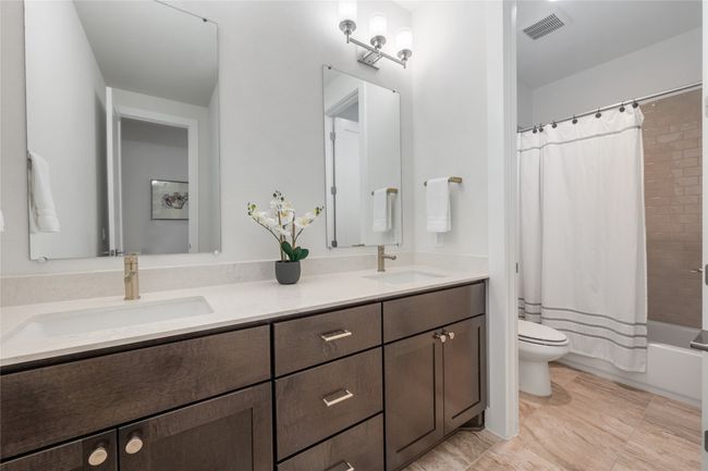 Full bathroom upstairs featuring double vanity. | Image 25