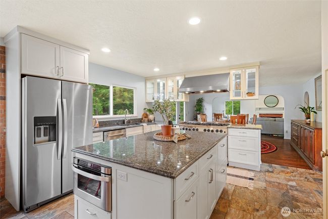 A large island with a built in microwave and plenty of space to gather and curate your meals. | Image 9