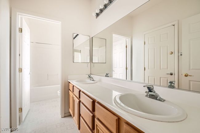 Full bathroom with double vanity and a sink | Image 23