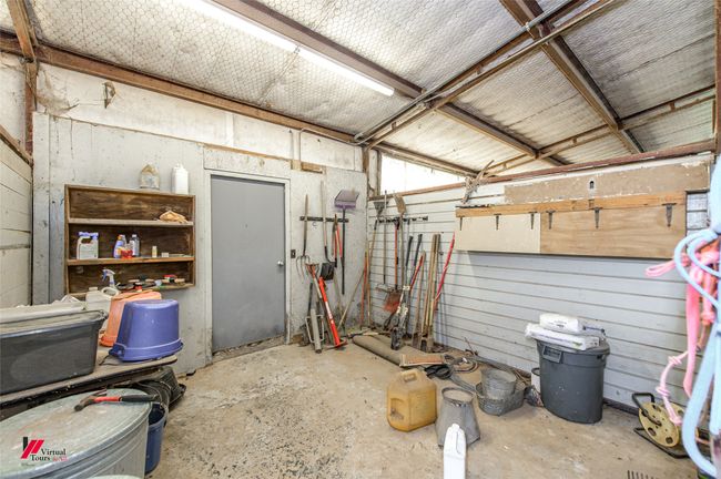 Storage or equipment room in the stable on concrete floor. | Image 12