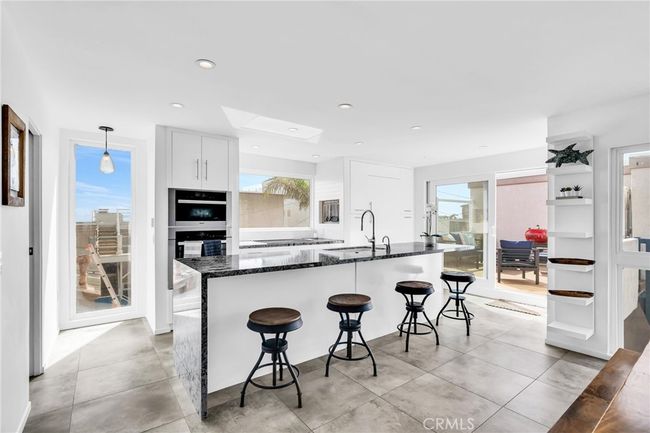 View of Kitchen with island and Meile Convection Oven, Convection Steam Oven and Cooktop | Image 7