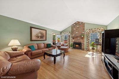 Cathedral ceiling and floor-to-ceiling fireplace m | Image 3