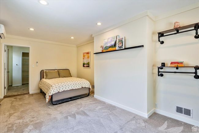 Bedroom with carpet, recessed lighting, a wall mounted AC, and crown molding | Image 30