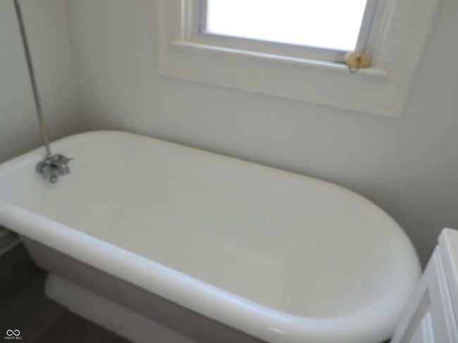 bathroom featuring a freestanding tub | Image 9