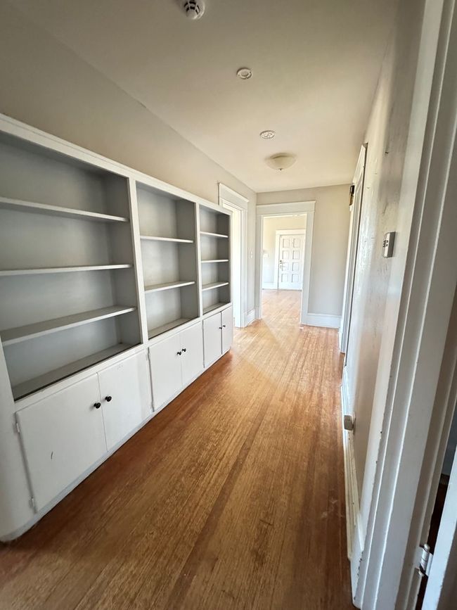 Hallway lined with bookshelves | Image 16