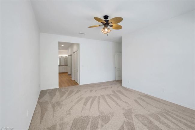 Unfurnished room with visible vents, a ceiling fan, and light carpet | Image 10