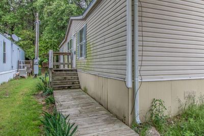 View of side of home featuring a wooden deck | Image 2