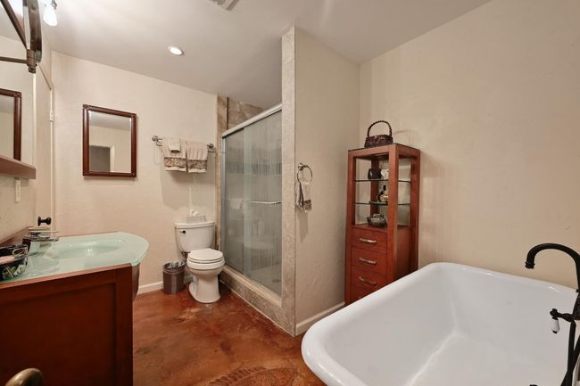 Beautifully updated full bath with a clawfoot soaking tub and separate walk-in shower. | Image 20