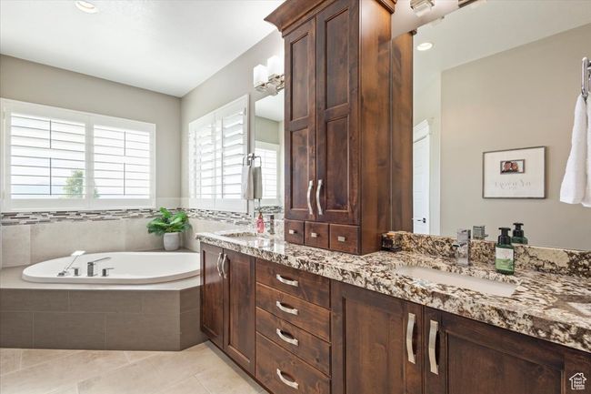 Bathroom with double vanity, a bath, and tile patterned floors | Image 35