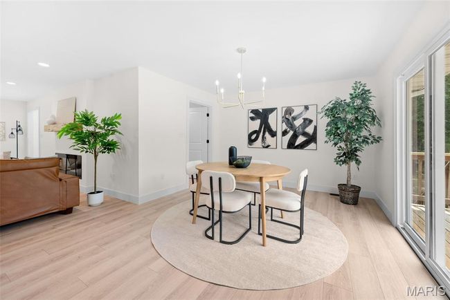 Dining space featuring a chandelier, light wood-type flooring, and recessed lighting | Image 19