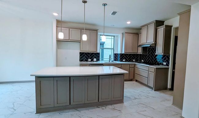 Kitchen featuring visible vents, marble finish floor, a sink, and tasteful backsplash | Image 10