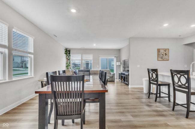 dining area with light wood finished floors, baseboards, visible vents, and recessed lighting | Image 10