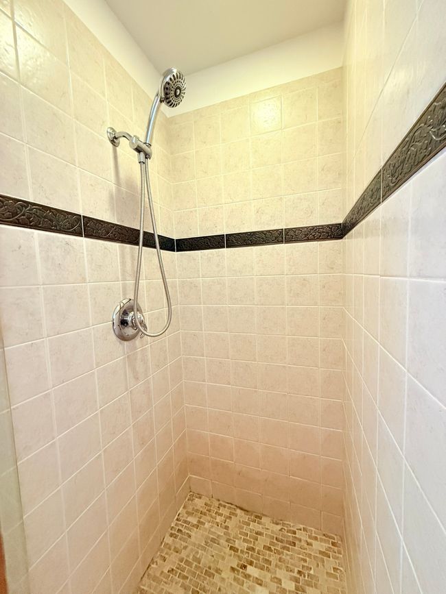 Bathroom featuring a tile shower | Image 28