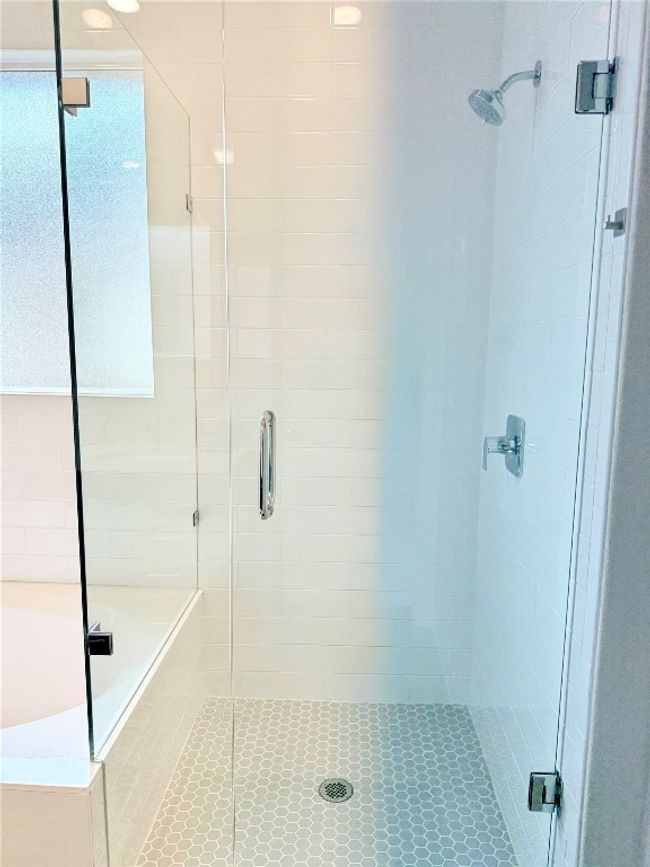 Modern bathroom with shower stall and decorative tile floors | Image 24