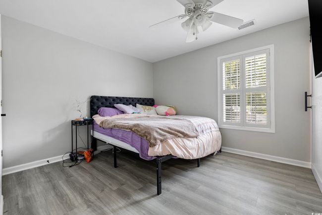 Bedroom featuring wood finished floors, baseboards, and a ceiling fan | Image 12
