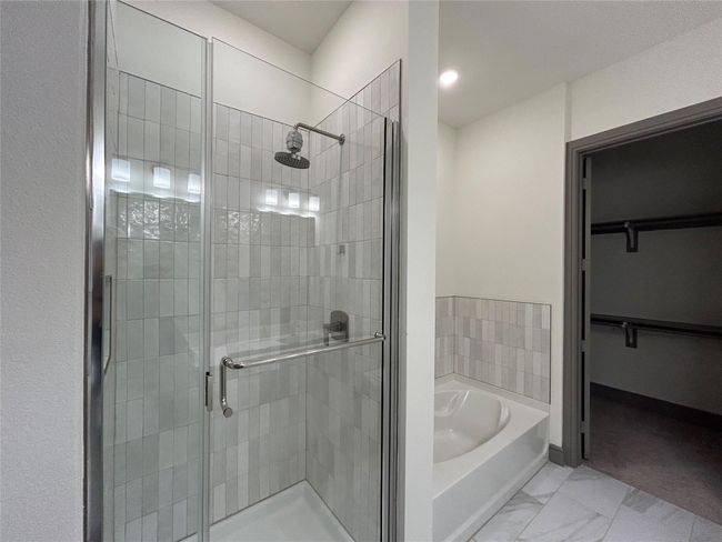Bathroom featuring shower with separate bathtub | Image 16