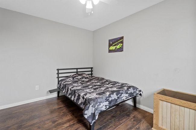 Bedroom featuring baseboards, wood finished floors, and a ceiling fan | Image 26