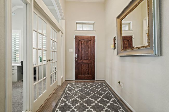 This entryway provides natural light and leading to an adjacent room. Creating a welcoming and elegant atmosphere. | Image 4