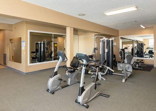 Workout area with a textured ceiling and carpet flooring | Image 20