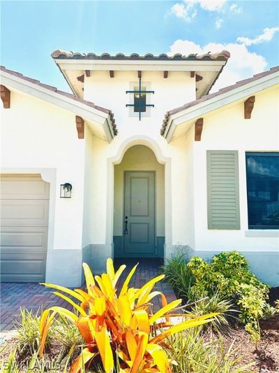 Doorway to property with a garage | Image 2