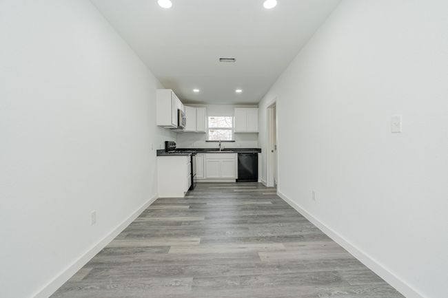 Kitchen with dishwasher, a sink, gas range, and baseboards | Image 5