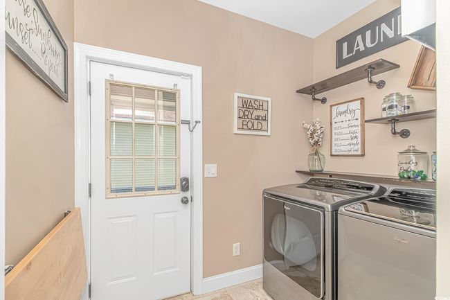 Laundry room featuring washing machine and dryer and baseboards | Image 15