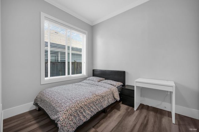 Bedroom with wood finished floors and ornamental molding | Image 26