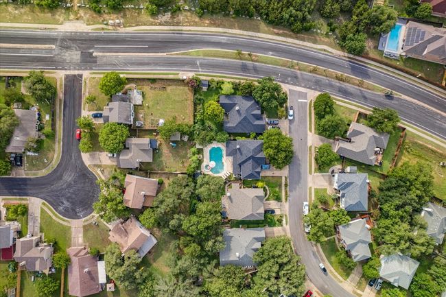 Aerial overview of property's location with nearby suburban area and a pool area | Image 32