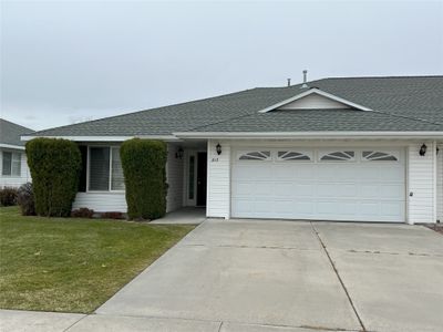 Single story home featuring a garage and a front lawn | Image 1